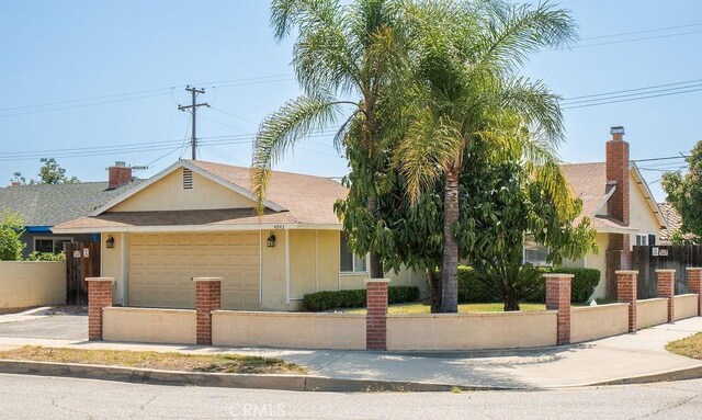 4943 Bresee Ave, Baldwin Park, CA 91706 - obstructed view of property featuring an attached garage, driveway, and a shingled roof