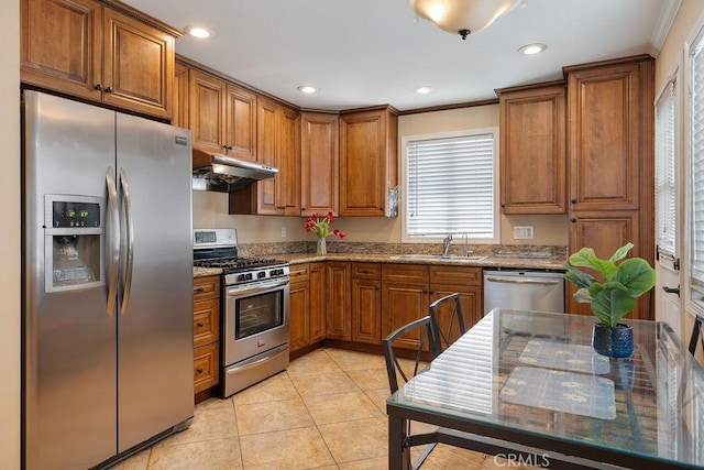 4943 Bresee Ave, Baldwin Park, CA 91706 - kitchen featuring stainless steel appliances, under cabinet range hood, brown cabinets, crown molding, and light stone countertops