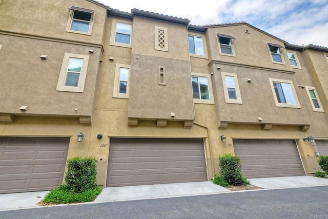 1201 Via Lucero, Oceanside, CA 92056 - back of house featuring stucco siding and an attached garage