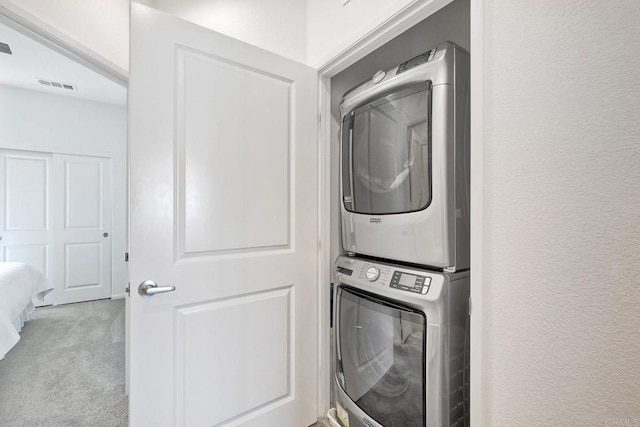 1201 Via Lucero, Oceanside, CA 92056 - laundry room with estacked washer and dryer, carpet, and a textured wall