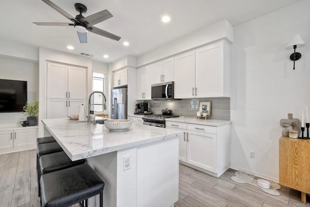 1201 Via Lucero, Oceanside, CA 92056 - kitchen featuring appliances with stainless steel finishes, backsplash, light wood-type flooring, a ceiling fan, and recessed lighting
