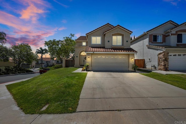 2435 Bear Rock, Escondido, CA 92026 - mediterranean / spanish house featuring stucco siding, a tiled roof, driveway, and a garage