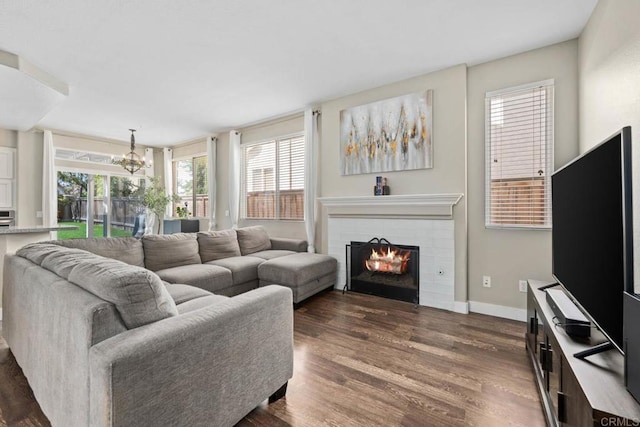 2435 Bear Rock, Escondido, CA 92026 - living area featuring healthy amount of natural light, dark wood-type flooring, a brick fireplace, and a chandelier