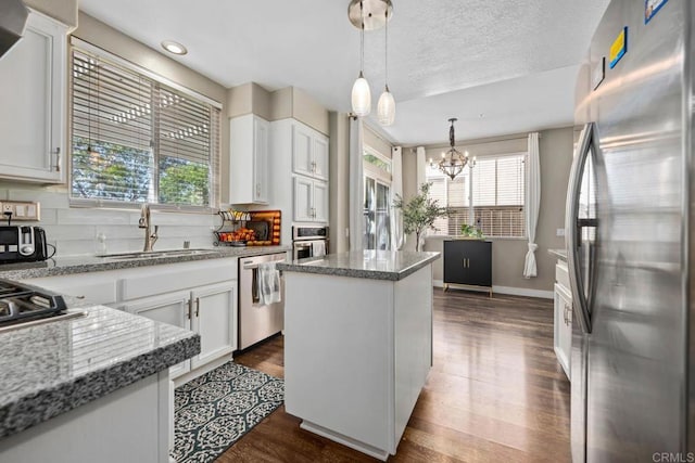 2435 Bear Rock, Escondido, CA 92026 - kitchen with appliances with stainless steel finishes, plenty of natural light, a kitchen island, a chandelier, and recessed lighting