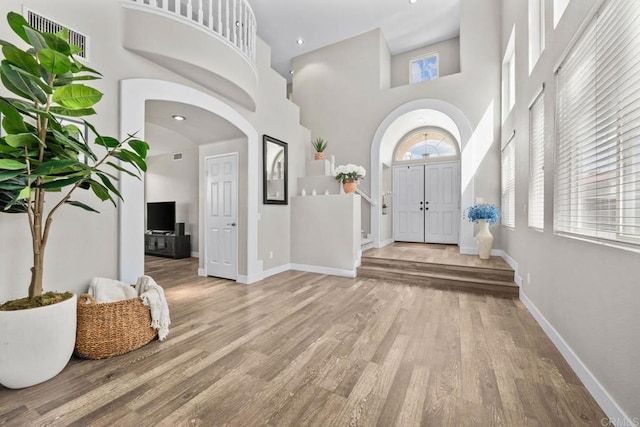 2435 Bear Rock, Escondido, CA 92026 - foyer featuring a towering ceiling, wood finished floors, and arched walkways
