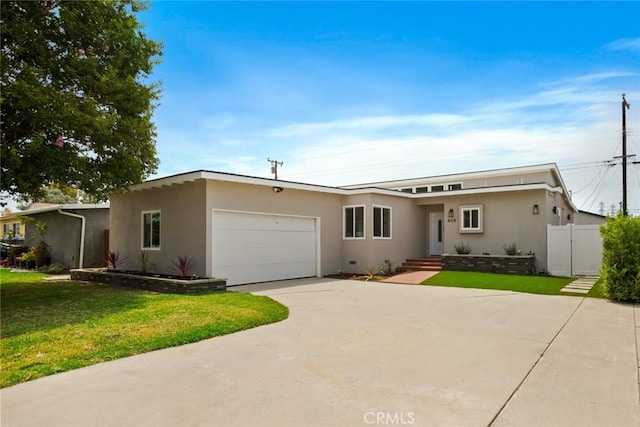 6118 Wolfe St, Lakewood, CA 90713 - view of front facade featuring a garage, stucco siding, and concrete driveway