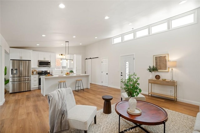6118 Wolfe St, Lakewood, CA 90713 - living area featuring light wood-style flooring and recessed lighting
