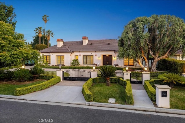 300 W Las Flores Ave, Arcadia, CA 91007 - view of front of house with a chimney, a gate, stucco siding, a fenced front yard, and a tiled roof