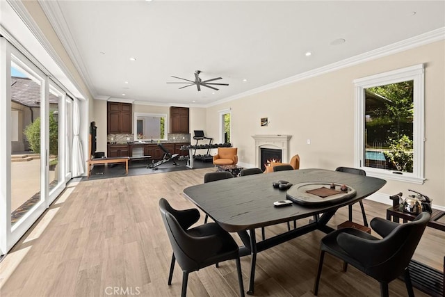 300 W Las Flores Ave, Arcadia, CA 91007 - dining area featuring a warm lit fireplace, light wood-style flooring, crown molding, ceiling fan, and recessed lighting