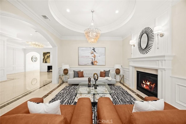 300 W Las Flores Ave, Arcadia, CA 91007 - living room featuring inlaid floor details, a chandelier, a raised ceiling, crown molding, and a decorative wall