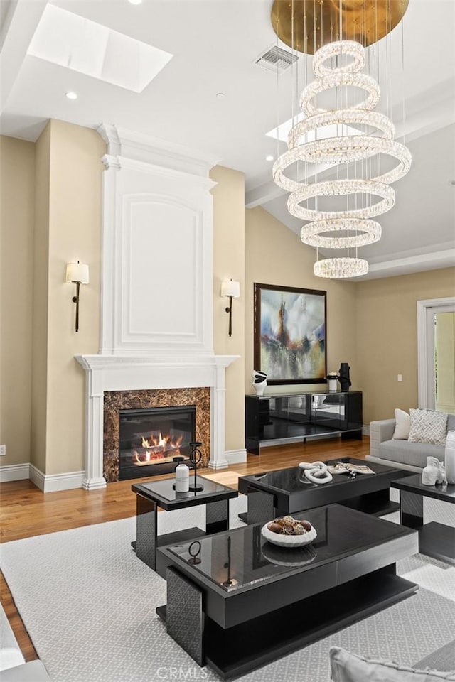 300 W Las Flores Ave, Arcadia, CA 91007 - living room with wood finished floors, a premium fireplace, a skylight, recessed lighting, and a chandelier