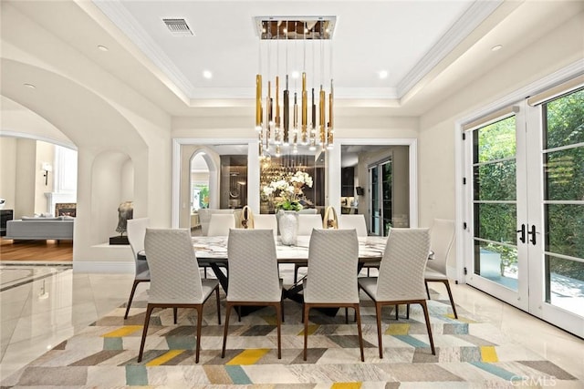 300 W Las Flores Ave, Arcadia, CA 91007 - dining area featuring arched walkways, a raised ceiling, ornamental molding, a chandelier, and french doors
