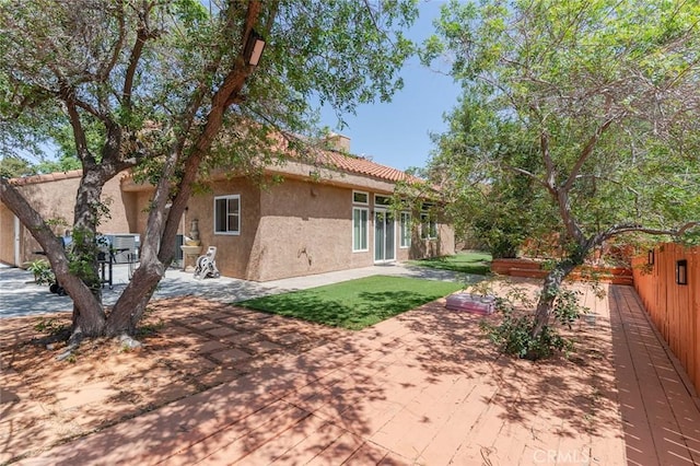 38342 5th Pl W, Palmdale, CA 93551 - rear view of property featuring stucco siding, a patio, and a chimney