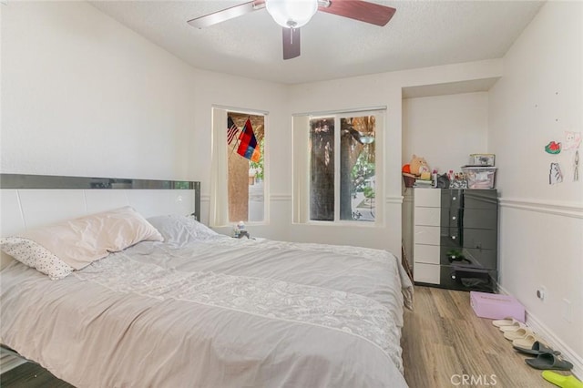 38342 5th Pl W, Palmdale, CA 93551 - bedroom featuring wood finished floors, a textured ceiling, and a ceiling fan