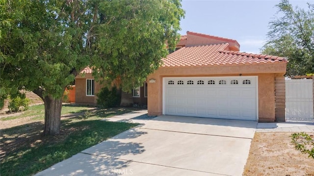 38342 5th Pl W, Palmdale, CA 93551 - view of front of house featuring a garage, concrete driveway, stucco siding, and a tiled roof