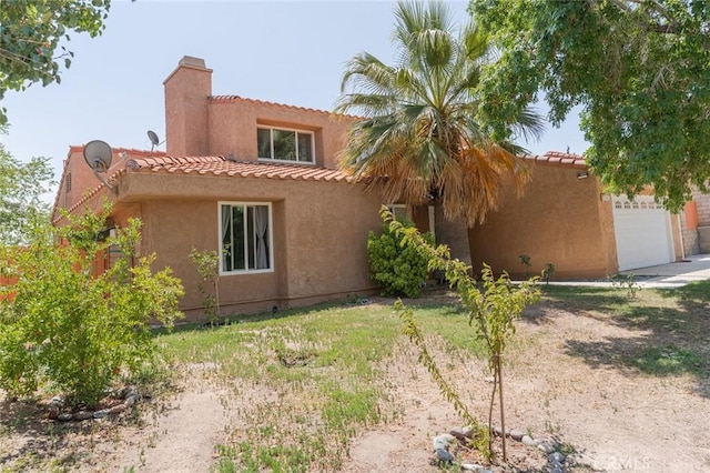 38342 5th Pl W, Palmdale, CA 93551 - mediterranean / spanish-style home featuring a chimney, a tiled roof, an attached garage, and stucco siding