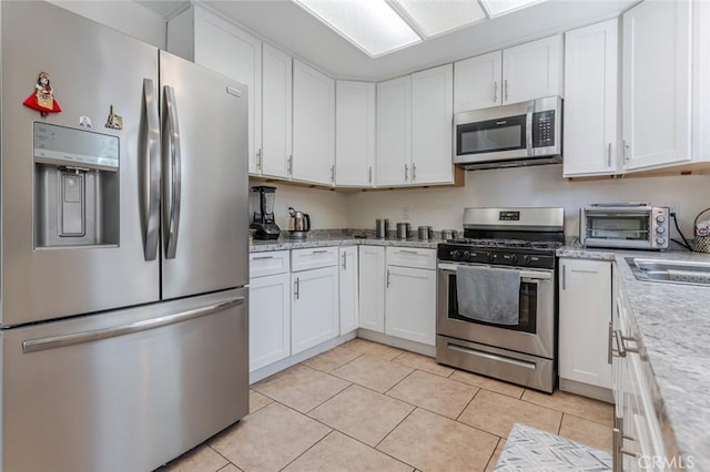 38342 5th Pl W, Palmdale, CA 93551 - kitchen featuring stainless steel appliances, light countertops, and white cabinets