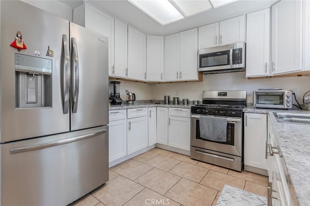 38342 5th Pl W, Palmdale, CA 93551 - kitchen with appliances with stainless steel finishes, light countertops, and white cabinets