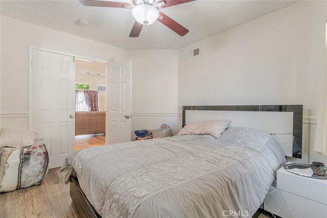 38342 5th Pl W, Palmdale, CA 93551 - bedroom featuring wood finished floors, a ceiling fan, and a textured ceiling