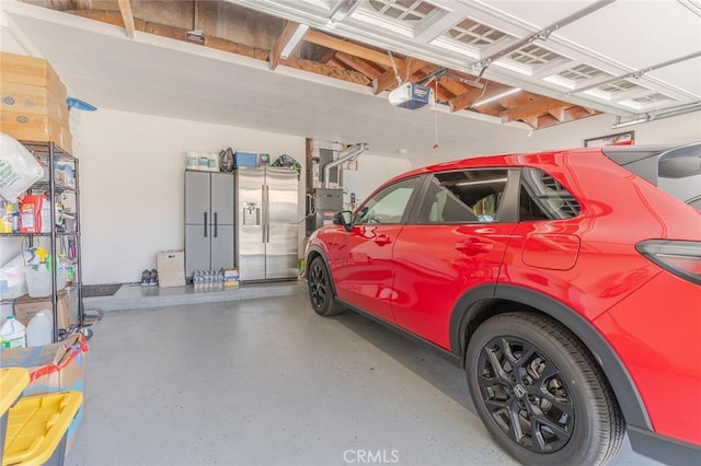 38342 5th Pl W, Palmdale, CA 93551 - garage with a garage door opener and stainless steel fridge with ice dispenser