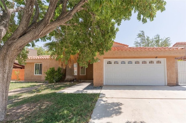 38342 5th Pl W, Palmdale, CA 93551 - view of front of property featuring concrete driveway, an attached garage, stucco siding, and a tiled roof