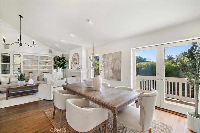 520 Kings Rd, Newport Beach, CA 92663 - dining space featuring a chandelier, wood finished floors, and high vaulted ceiling