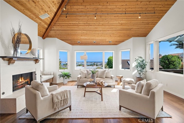 520 Kings Rd, Newport Beach, CA 92663 - living area featuring track lighting, a wooden ceiling with exposed beams, plenty of natural light, a high end fireplace, and wood finished floors
