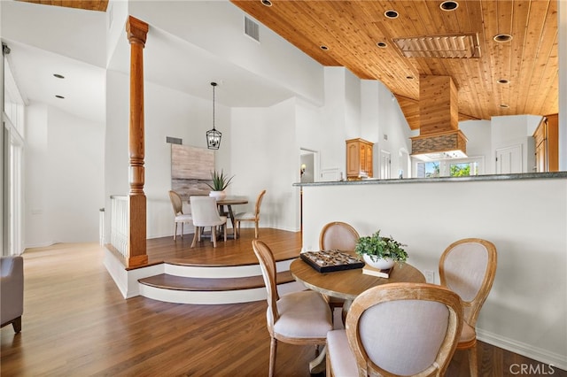 520 Kings Rd, Newport Beach, CA 92663 - dining space featuring wooden ceiling, wood finished floors, a towering ceiling, ornate columns, and recessed lighting