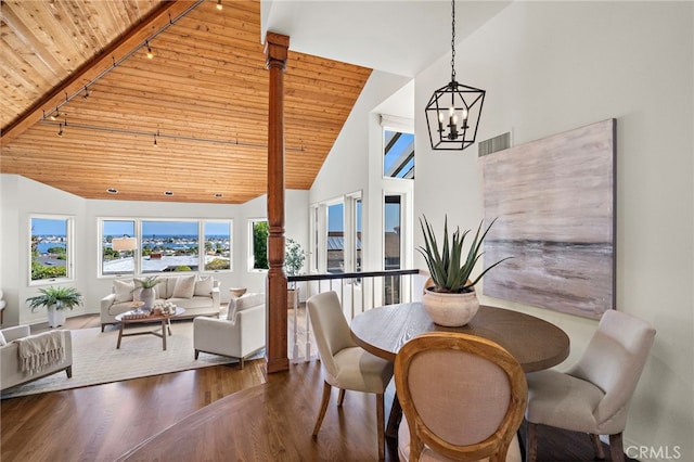 520 Kings Rd, Newport Beach, CA 92663 - dining space with wood ceiling, a chandelier, high vaulted ceiling, wood finished floors, and rail lighting