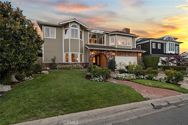 520 Kings Rd, Newport Beach, CA 92663 - view of front facade featuring a chimney, a front lawn, an attached garage, brick siding, and decorative driveway