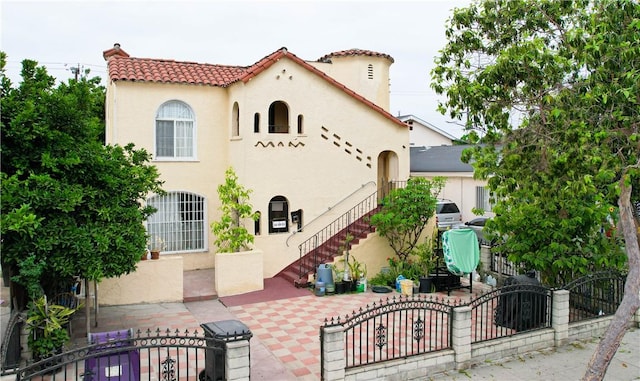 1451 Walnut Ave, Long Beach, CA 90813 - mediterranean / spanish house featuring stucco siding, a fenced front yard, and a gate