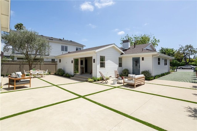 212 E 19th St, Costa Mesa, CA 92627 - back of property featuring an outdoor hangout area, a patio area, and a chimney