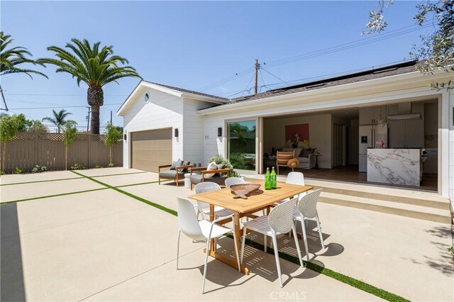 212 E 19th St, Costa Mesa, CA 92627 - view of patio / terrace with a garage, driveway, and outdoor dining space