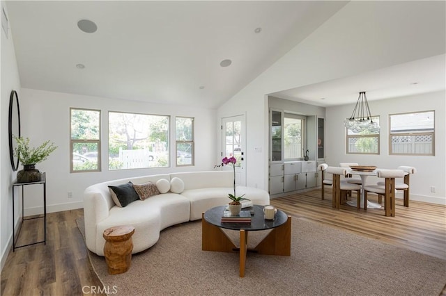 212 E 19th St, Costa Mesa, CA 92627 - living area featuring wood finished floors, a chandelier, and high vaulted ceiling