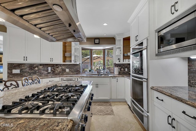 9999 Wornom Ave, Sunland, CA 91040 - kitchen with extractor fan, stainless steel appliances, light tile patterned floors, dark stone counters, and white cabinetry