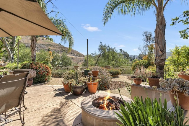 9999 Wornom Ave, Sunland, CA 91040 - fenced backyard with a patio, a fire pit, and a mountain view