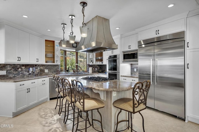 9999 Wornom Ave, Sunland, CA 91040 - kitchen with built in appliances, island range hood, light tile patterned floors, white cabinets, and recessed lighting