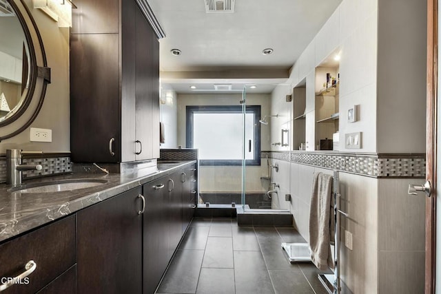 9999 Wornom Ave, Sunland, CA 91040 - full bath featuring vanity, tile patterned floors, a shower stall, tile walls, and wainscoting