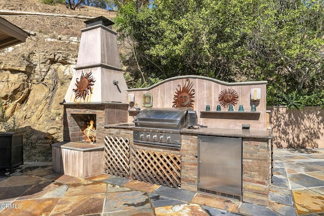 9999 Wornom Ave, Sunland, CA 91040 - view of patio featuring a warm lit fireplace and exterior kitchen