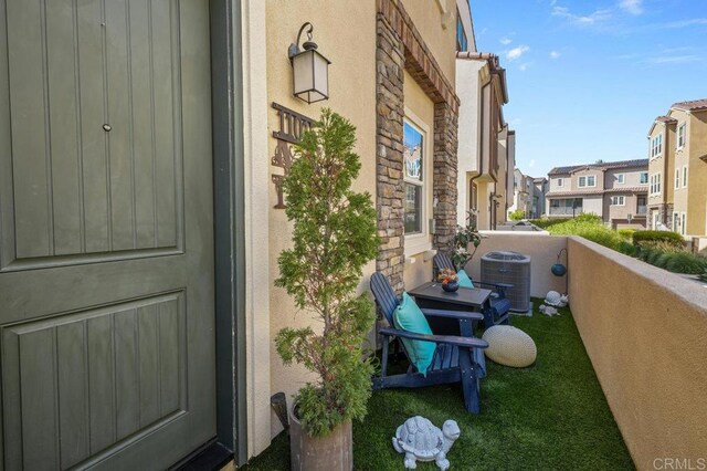 11015 Peyton Way, San Diego, CA 92129 - view of exterior entry featuring stone siding, a balcony, a residential view, and stucco siding