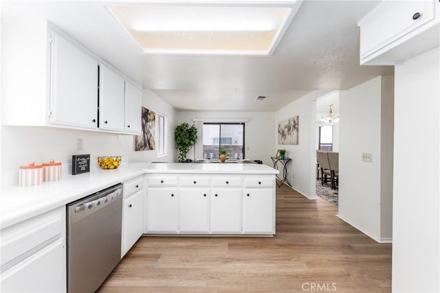1407 Sycamore Ln, San Bernardino, CA 92408 - kitchen featuring dishwasher, a peninsula, a chandelier, light countertops, and white cabinets