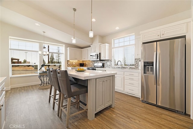 635 Boquest Blvd, Paradise, CA 95969 - kitchen with appliances with stainless steel finishes, lofted ceiling, decorative backsplash, wood finished floors, and light countertops