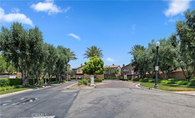 5680 Kate Way Unit 5, Fontana, CA 92336 - view of asphalt road with a residential view, curbs, street lighting, sidewalks, and a gated entry