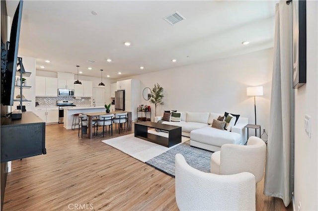 5680 Kate Way Unit 5, Fontana, CA 92336 - living area featuring light wood finished floors and recessed lighting