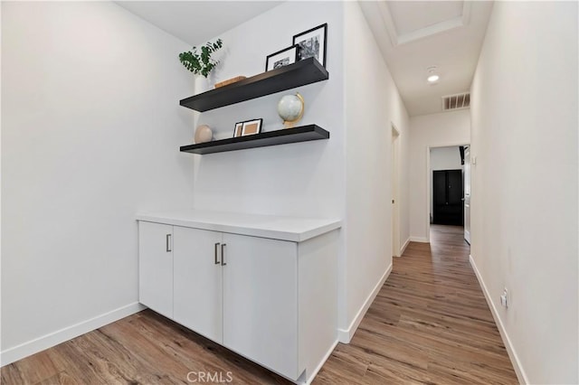 5680 Kate Way Unit 5, Fontana, CA 92336 - hallway featuring light wood-style flooring and attic access