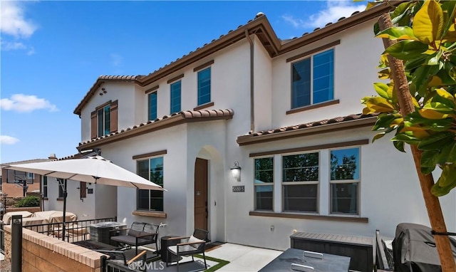 5680 Kate Way Unit 5, Fontana, CA 92336 - rear view of property featuring stucco siding, a tile roof, and a patio area