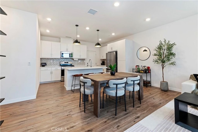 5680 Kate Way Unit 5, Fontana, CA 92336 - dining area featuring light wood-style floors and recessed lighting