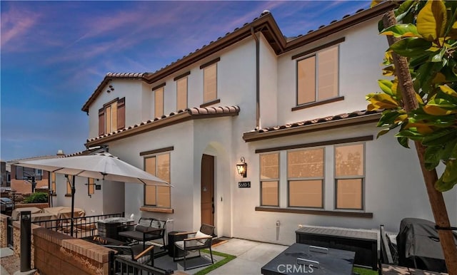 5680 Kate Way Unit 5, Fontana, CA 92336 - back of house at dusk featuring stucco siding, a patio, and a tile roof