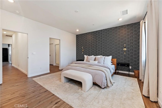 5680 Kate Way Unit 5, Fontana, CA 92336 - bedroom featuring an accent wall, wallpapered walls, wood finished floors, and recessed lighting