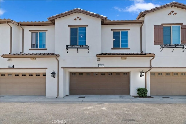5680 Kate Way Unit 5, Fontana, CA 92336 - view of front of house with a tile roof, an attached garage, and stucco siding